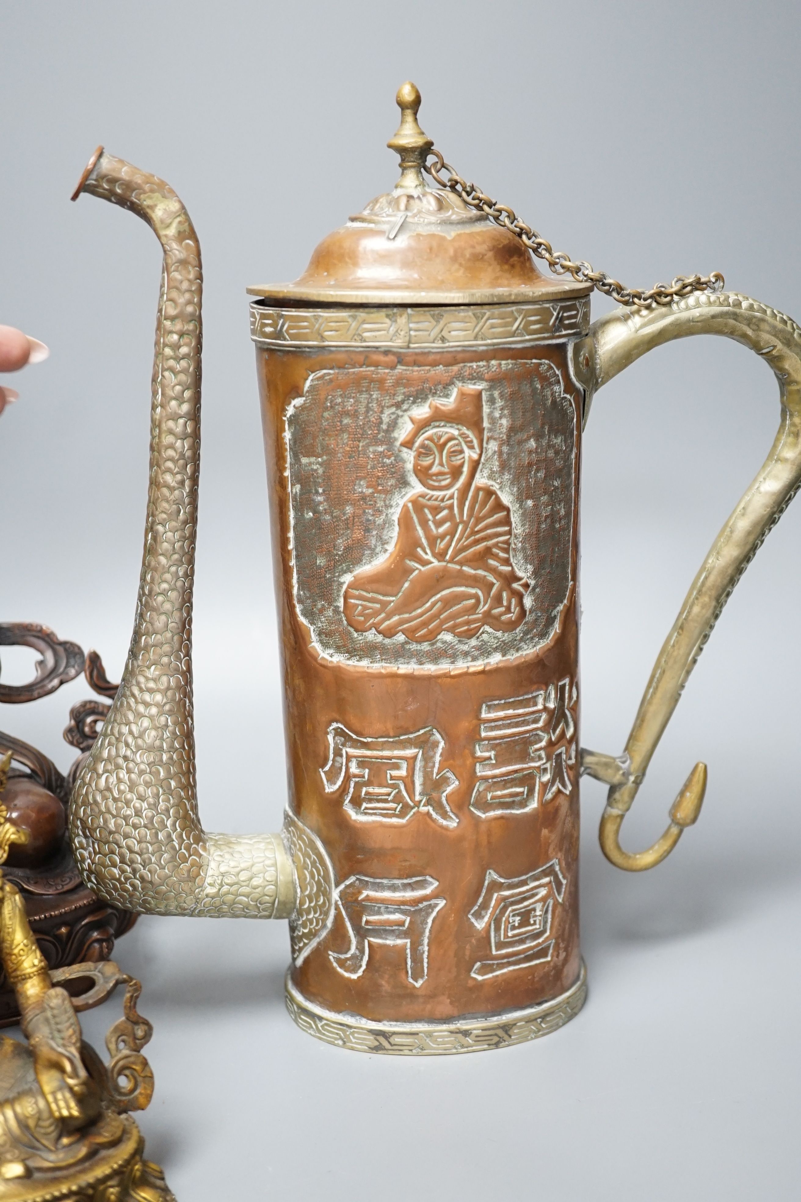 A Tibetan copper and brass ewer, together with a gilt-metal bodhisattva and another bronze bodhisattva, tallest 31cm